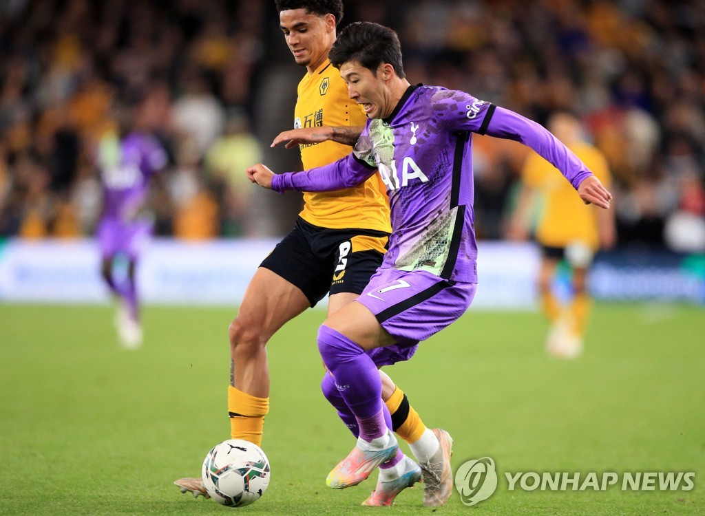 In this AFP photo, Son Heung-min of Tottenham Hotspur (R) battles Ki-Jana Hoever of Wolverhampton Wanderers during the third round match of the Carabao Cup at Molineux Stadium in Wolverhampton, England, on Sept. 22, 2021. (Yonhap)