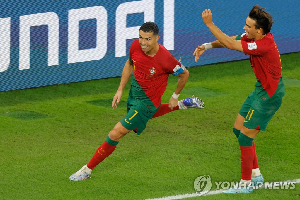In this AFP photo, Cristiano Ronaldo of Portugal (L) celebrates after scoring a penalty against Ghana during the teams' Group H match at Stadium 974 in Doha on Nov. 24, 2022. (Yonhap)