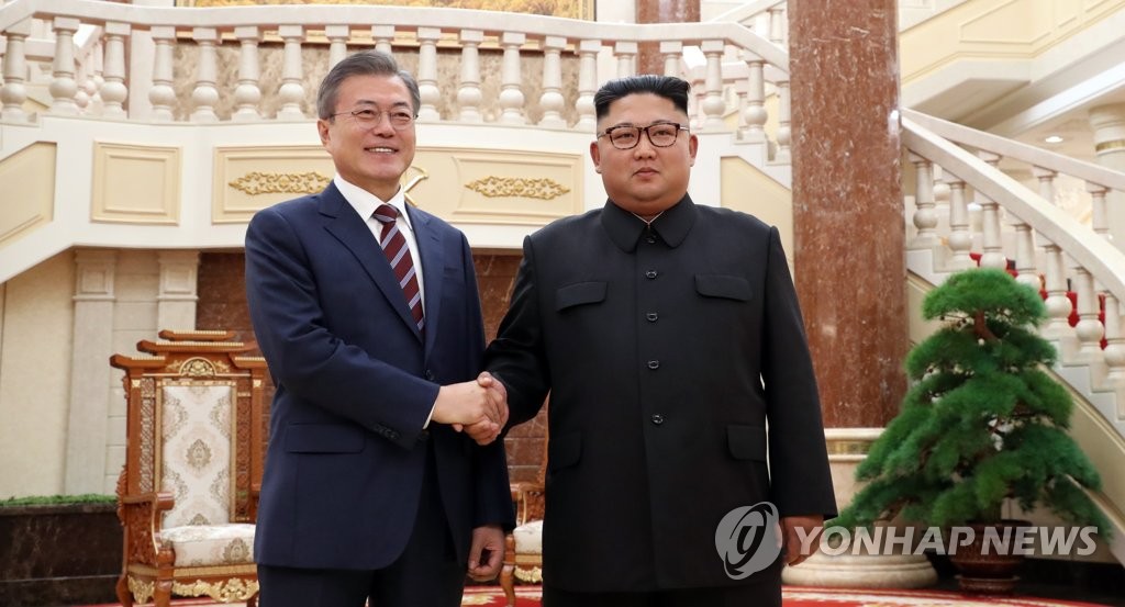 This file photo shows South Korean President Moon Jae-in (L) and North Korean leader Kim Jong-un shaking hands before their summit talks at the headquarters of the North's Workers' Party Central Committee in Pyongyang on Sept. 18, 2018. (Pool photo) (Yonhap)