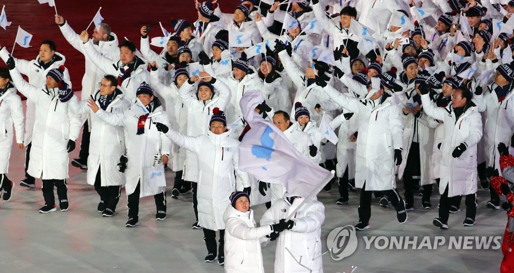 This photo, taken Feb. 9, 2018, shows athletes from South and North Korea marching together under a unification flag during the opening ceremony of the PyeongChang Winter Olympic Games in PyeongChang, Gangwon Province. (Yonhap)