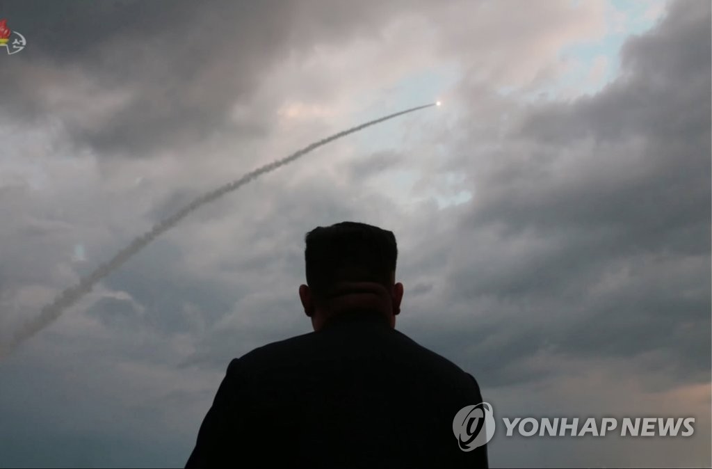 This photo captured from Pyongyang's state TV on Aug. 1, 2019, shows leader Kim Jong-un watching the test-firing of what North Korea claims to be a newly developed large-caliber multiple launch guided rocket system. (For Use Only in the Republic of Korea. No Redistribution) (Yonhap)