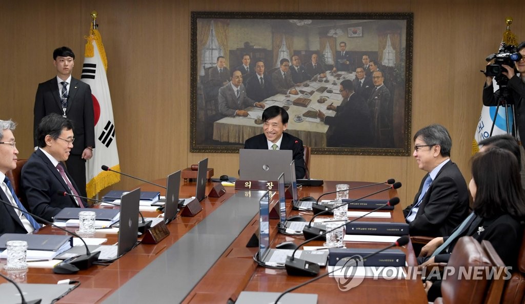 In the photo, taken Jan. 17, 2020, Bank of Korea Gov. Lee Ju-yeol (C) speaks with other members of the BOK monetary policy board before the start of the board's first rate-setting meeting of the year, in which the 7-member board voted 5-2 to keep the base rate frozen at 1.25 percent. (Yonhap)