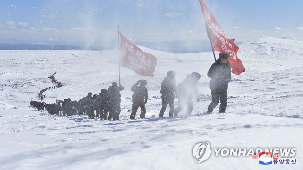 This photo, released by the Korean Central News Agency, shows deputies of North Korea's Supreme People's Assembly climbing Mount Paekdu bordering China on an expedition to revolutionary battle sites on Feb. 26, 2020. (For Use Only in the Republic of Korea. No Redistribution) (Yonhap)