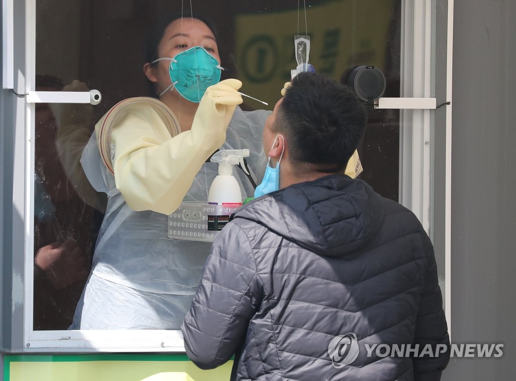 A man is tested at a walkthrough screening center set up at Seoul Sports Complex in southeastern Seoul on April 3, 2020. (Yonhap)