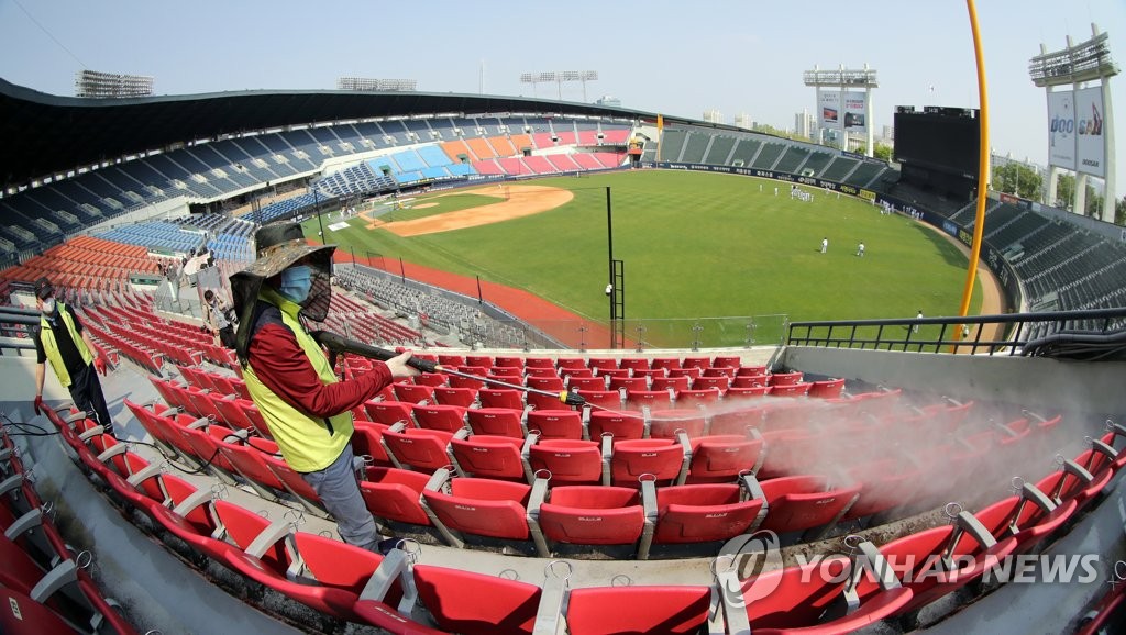 Public health workers sanitize seats at Jamsil Stadium in Seoul on May 1, 2020, four days prior to the start of the 2020 Korea Baseball Organization season. (Yonhap)