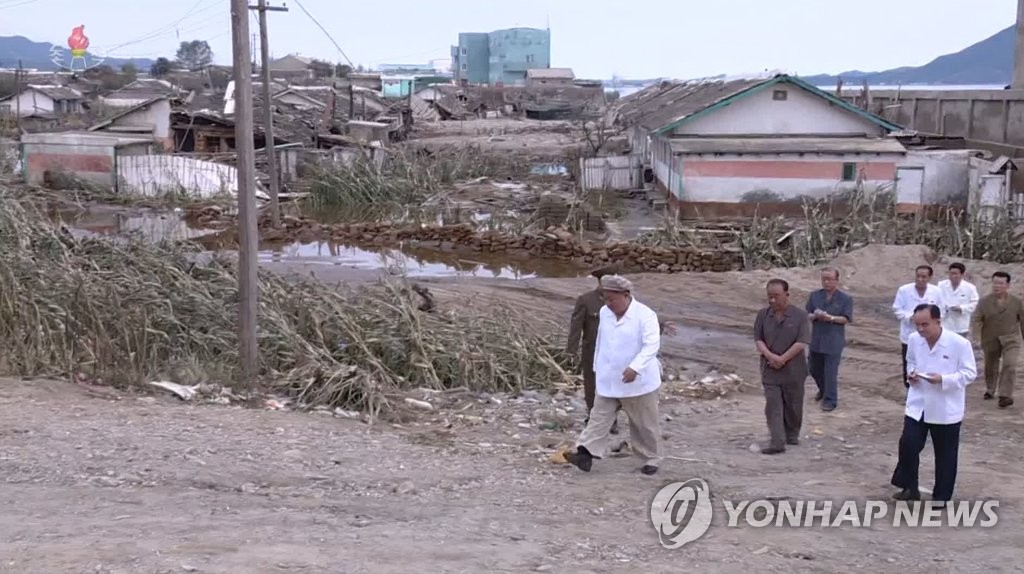 North Korean leader Kim Jong-un (L) inspects an area damaged by Typhoon Maysak in the country's eastern South Hamgyong Province, in this image captured from the Korean Central Television Broadcasting Station on Sept. 6, 2020. (For Use Only in the Republic of Korea. No Redistribution)(Yonhap)