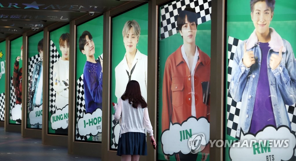 A visitor walks past advertising signage showing K-pop septet BTS at a department store in Seoul on Sept. 9, 2020. The band's song "Dynamite" secured the No. 1 spot on Billboard's main singles chart for the second week in a row the previous day. (Yonhap)