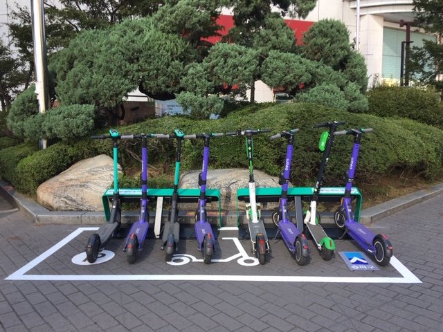 Electric scooters are parked at a designated zone for personal mobility devices in front of Jamsil Station in southern Seoul, in this photo provided by the Songpa District Ward Office on Oct. 7, 2020. (PHOTO NOT FOR SALE) (Yonhap)