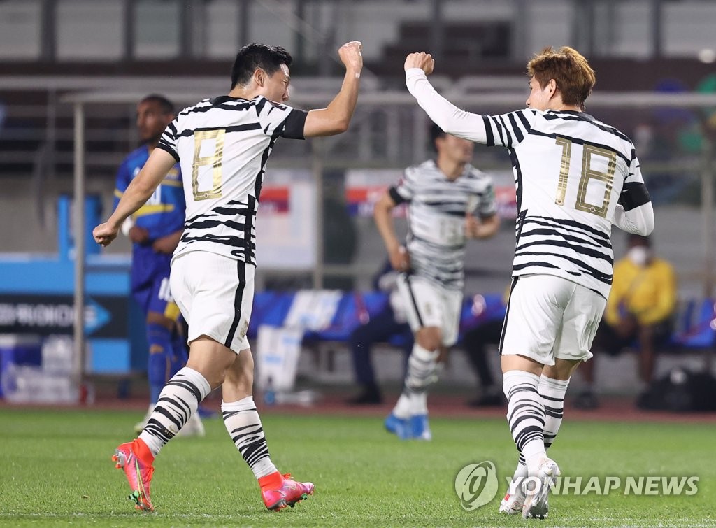 Lee Dong-gyeong of South Korea (R) celebrates his goal against Sri Lanka with teammate Nam Tae-hee during the teams' Group H match in the second round of the Asian qualification for the 2022 FIFA World Cup at Goyang Stadium in Goyang, Gyeonggi Province, on June 9, 2021. (Yonhap)