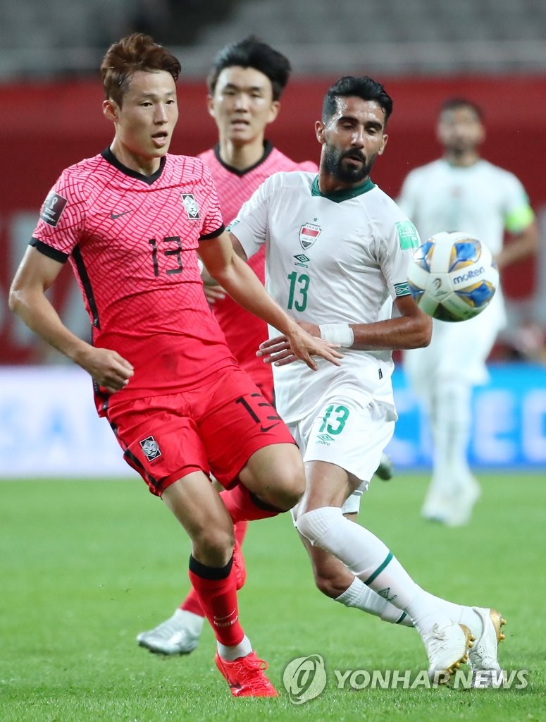 In this file photo from Sept. 2, 2021, Son Jun-ho of South Korea (L) and Bashar Resan of Iraq battle for the ball during the teams' Group A match in the final Asian qualifying round for the 2022 FIFA World Cup at Seoul World Cup Stadium in Seoul. (Yonhap)