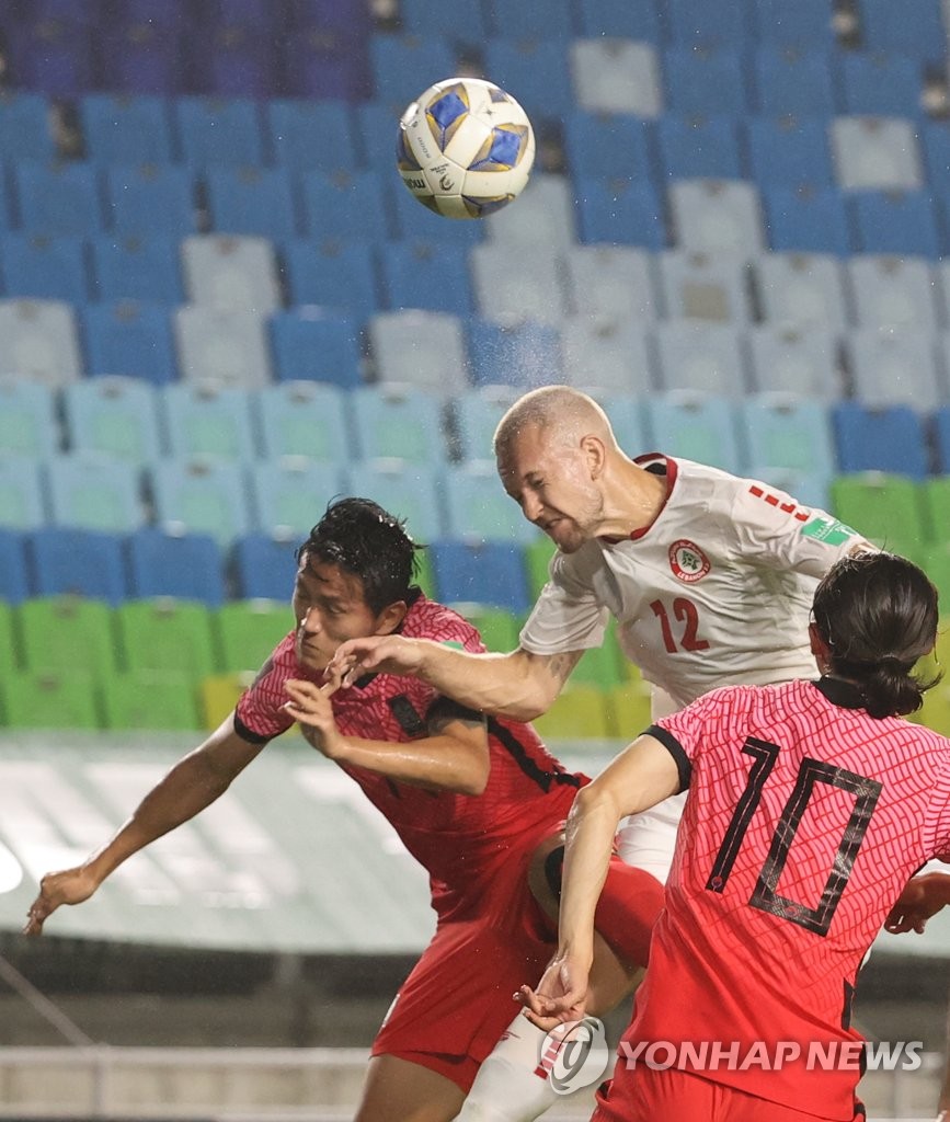 In this file photo, Hong Chul of South Korea (L) and Robert Melki of Lebanon (C) battle for the ball during the teams' Group A match in the final Asian qualifying round for the 2022 FIFA World Cup at Suwon World Cup Stadium in Suwon, Gyeonggi Province, on Sept. 7, 2021. (Yonhap)