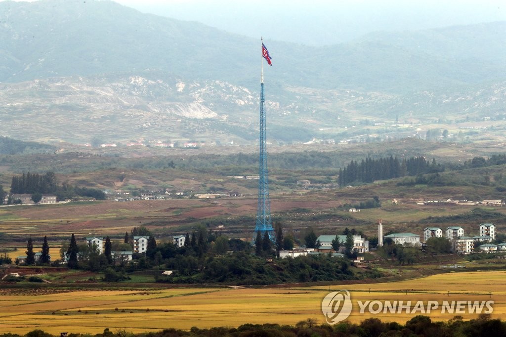 This photo, taken from a South Korean observation tower in Paju, north of Seoul, on Sept. 29, 2021, shows the North Korean flag fluttering at a North Korean border village inside the Demilitarized Zone bisecting the two Koreas. (Yonhap)