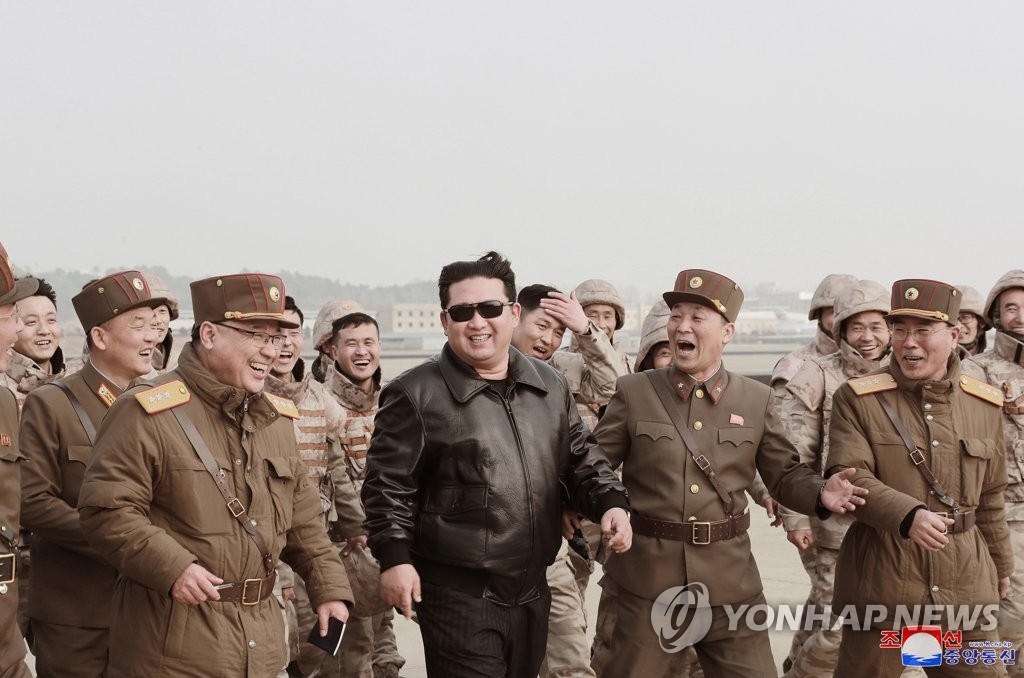 North Korean leader Kim Jong-un (C) celebrates with soldiers of the country's strategic forces after a Hwasong-17 intercontinental ballistic missile (ICBM) was launched from Pyongyang International Airport on March 24, 2022, in this photo released by North Korea's official Korean Central News Agency. (For Use Only in the Republic of Korea. No Redistribution) (Yonhap)