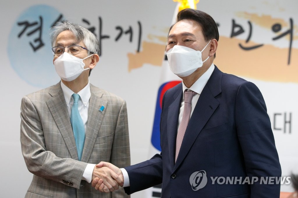 South Korean President-elect Yoon Suk-yeol (R) poses with Japanese Ambassador to South Korea Koichi Aiboshi during their meeting at the presidential transition committee's office in Seoul on March 28, 2022. (Pool photo) (Yonhap)