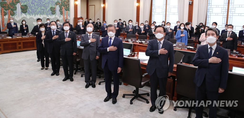 Outgoing President Moon Jae-in (3rd from R) salutes the national flag during his last Cabinet meeting at the presidential office in Seoul on May 3, 2022. His term will end on May 9. (Yonhap)