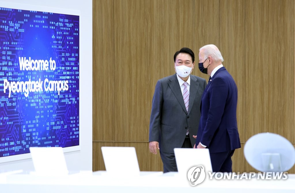 President Yoon Suk-yeol (L) and U.S. President Joe Biden tour a Samsung Electronics semiconductor plant in Pyeongtaek, 70 kilometers south of Seoul, on May 20, 2022. (Yonhap)