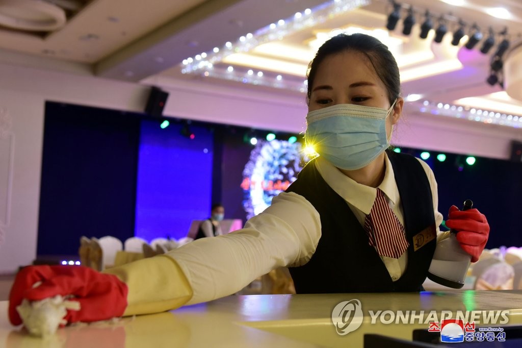 An employee of Ryugyong Golden Department Store in Pyongyang carries out disinfectant work, in this file photo released by the North's Korean Central News Agency on June 15, 2022. (For Use Only in the Republic of Korea. No Redistribution) (Yonhap)