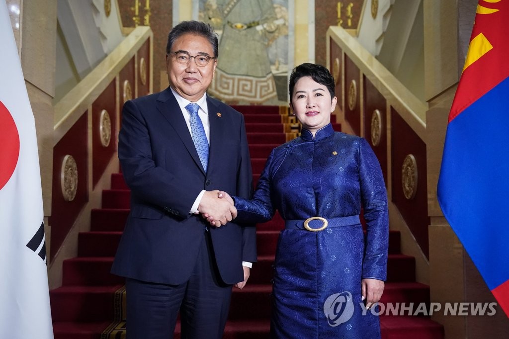 South Korean Foreign Minister Park Jin (L) shakes hands with his Mongolian counterpart, Batmunkh Battsetseg, during their talks in Ulaanbaatar on Aug. 29, 2022, in this photo provided by Parks' office. (PHOTO NOT FOR SALE) (Yonhap)