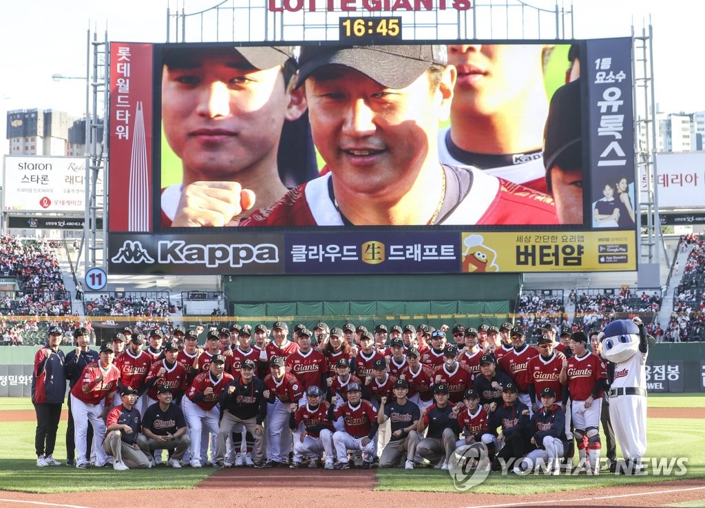 Players and coaches for the Lotte Giants pose for a group photo before the start of the final Korea Baseball Organization regular season game for Lotte player Lee Dae-ho (shown on the screen) at Sajik Baseball Stadium in Busan, 325 kilometers southeast of Seoul, on Oct. 8, 2022. (Yonhap)