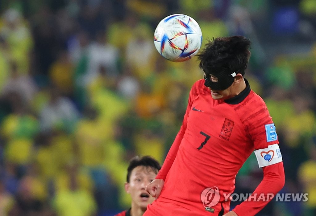 Son Heung-min of South Korea heads the ball against Brazil during the countries' round of 16 match at the FIFA World Cup at Stadium 974 in Doha on Dec. 5, 2022. (Yonhap)