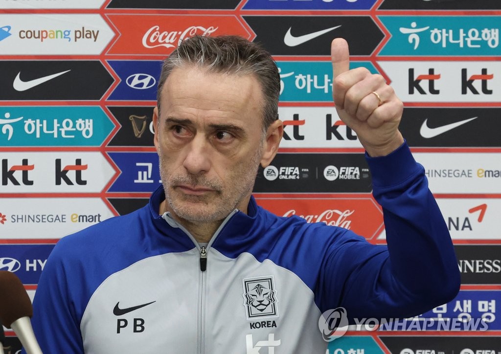 South Korea head coach Paulo Bento gives a thumbs-up sign to fans during his media scrum at Incheon International Airport, just west of Seoul, after returning home from the FIFA World Cup in Qatar on Dec. 7, 2022. (Yonhap)