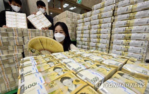Staff members inspect bills at a branch of the Bank of Korea in Suwon, south of Seoul, on Jan. 17, 2023. (Pool photo) (Yonhap)