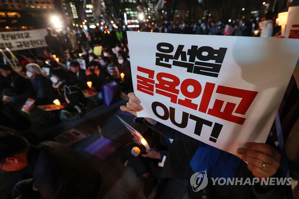 Social activists supporting the victims of Japan's wartime forced labor condemn the compensation plan announced by the government of President Yoon Suk Yeol, holding signs that read "Yoon Suk Yeol humiliating diplomacy out!" in central Seoul on March 6, 2023. (Yonhap)