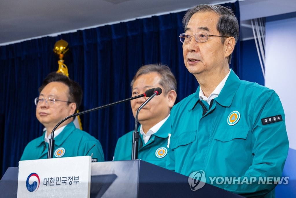 Prime Minister Han Duck-soo (R) makes a public speech at the government complex in Seoul on Aug. 23, 2023. (Yonhap)
