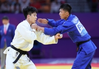 Jeux asiatiques : le judoka sud-coréen An Baul bat le Nord-Coréen Ri Kum-song dans le 1er duel coréen
