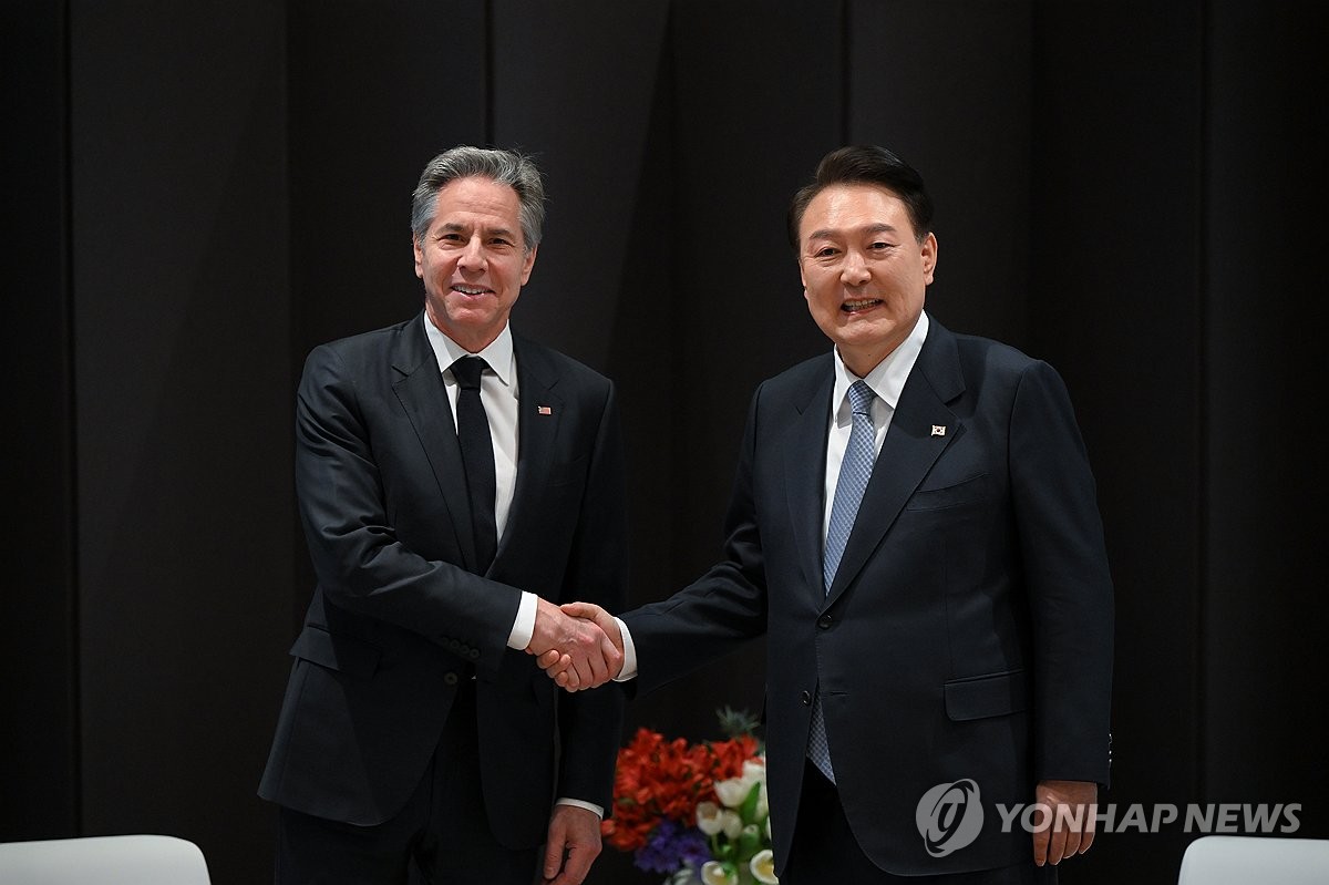 President Yoon Suk Yeol (L) and U.S. Secretary of State Antony Blinken shake hands while meeting on the sidelines of the ministerial conference of the third Summit for Democracy at Hotel Shilla in Seoul on March 18, 2024, in this photo provided by the presidential office. (PHOTO NOT FOR SALE) (Yonhap)